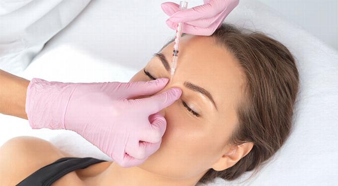 lady receiving injection between eyebrows 
